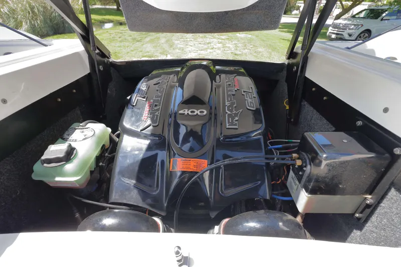 Slide: The Image of Interior view of a 2018 Sanger 212 SL boat storage compartment with hoses and equipment. - 20