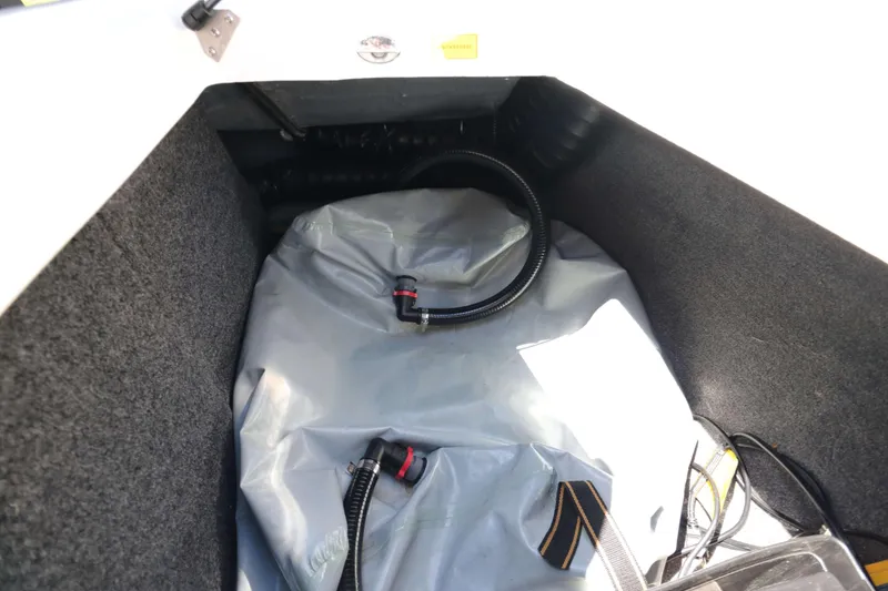 Slide: The Image of Interior view of a 2018 Sanger 212 SL boat storage compartment with hoses. - 21