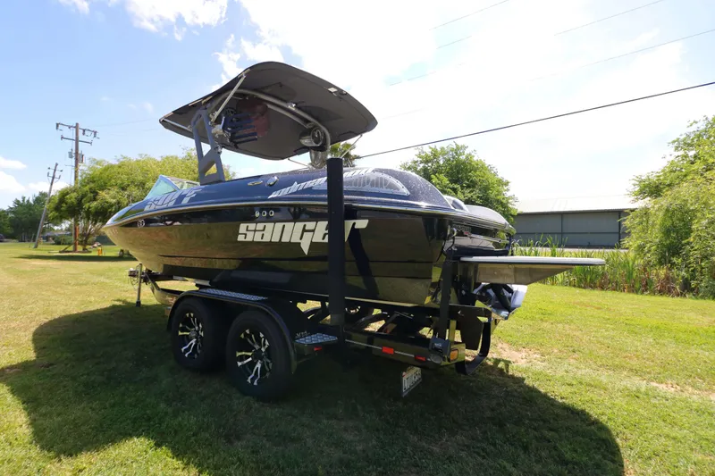Slide: The Image of Rear view of a 2018 Sanger 212 SL boat with propeller and trim tabs. - 6