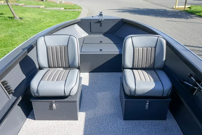 Slide: The Image of 2026 Alumaweld Adventurer 20 boat interior with two cushioned seats and storage compartments. - 12
