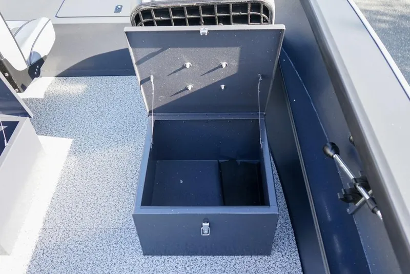 Slide: The Image of Open storage compartment in 2026 Alumaweld Adventurer 20 boat, featuring a textured floor. - 14
