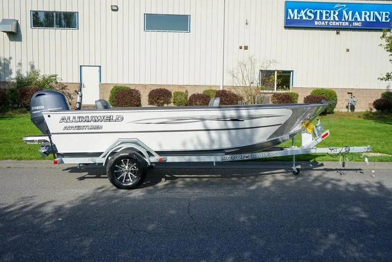 Slide: The Image of 2026 Alumaweld Adventurer 20 boat on trailer, parked outside Master Marine Boat Center. - 3
