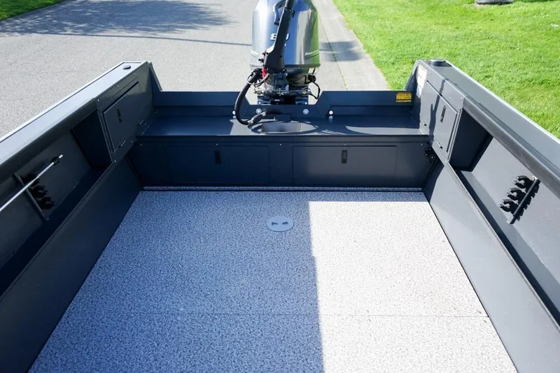 Slide: The Image of 2026 Alumaweld Adventurer 20 boat interior with motor, spacious deck, and storage compartments. - 7
