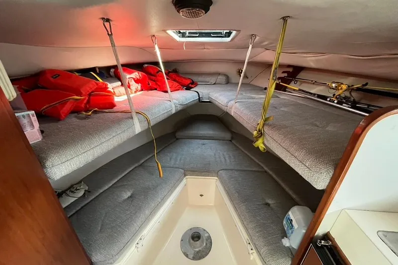 Slide: The Image of 1992 Rampage 28 Sportsman cabin interior with life jackets and fishing rods. - 10