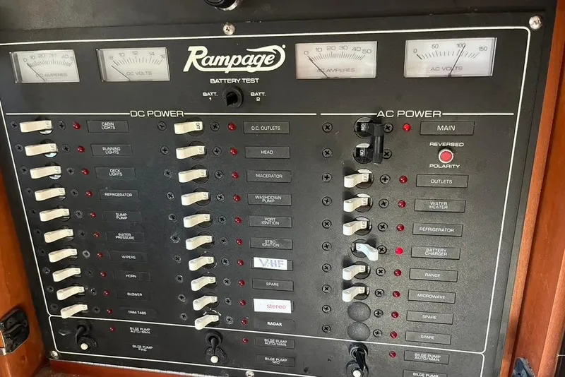 Slide: The Image of Control panel of a 1992 Rampage 28 Sportsman boat, featuring DC and AC power switches. - 12