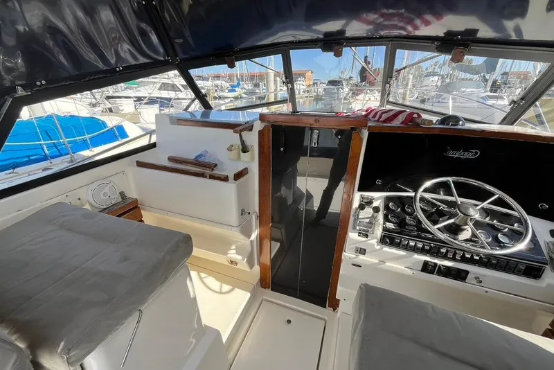 Slide: The Image of Interior view of a 1992 Rampage 28 Sportsman boat cockpit with steering wheel and controls. - 13