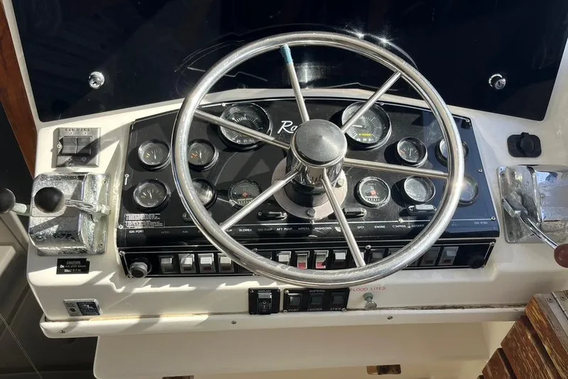 Slide: The Image of 1992 Rampage 28 Sportsman boat dashboard with steering wheel and control panel. - 7