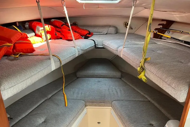 Slide: The Image of Interior cabin of a 1992 Rampage 28 Sportsman boat with life jackets and cushioned seating. - 8