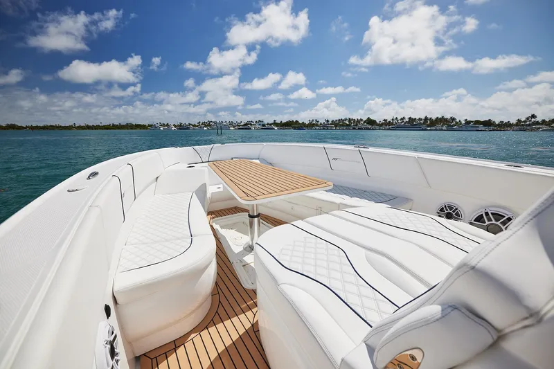 Slide: The Image of Luxurious 2024 Midnight Express boat interior with white seating and wooden table on open water. - 11