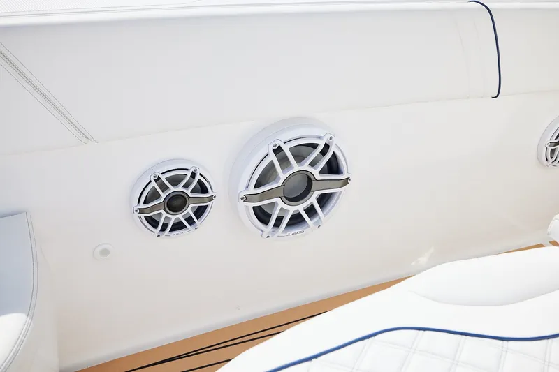 Slide: The Image of 2024 Midnight Express boat speakers, white interior, JL Audio branding, luxury marine sound system. - 12