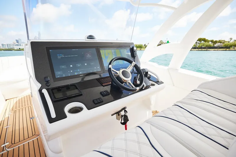 Slide: The Image of 2024 Midnight Express boat cockpit with modern steering and navigation system. - 13