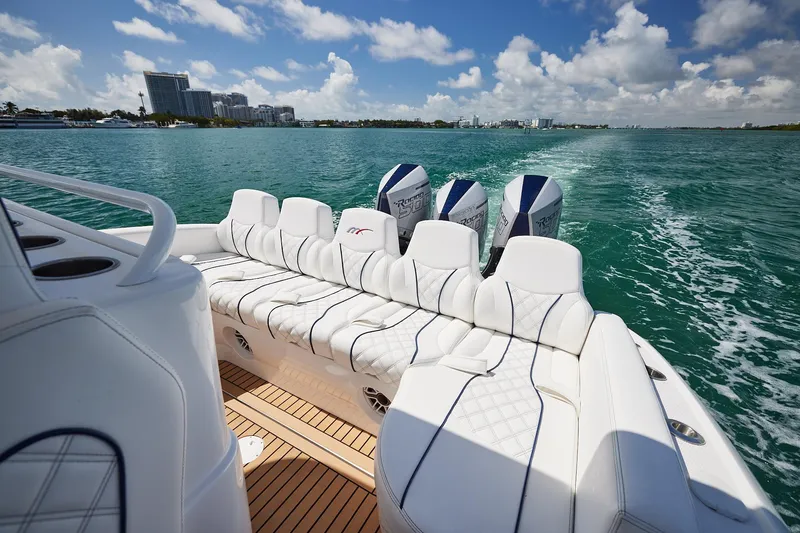 Slide: The Image of Luxurious 2024 Midnight Express boat with plush seating cruising on turquoise waters. - 17