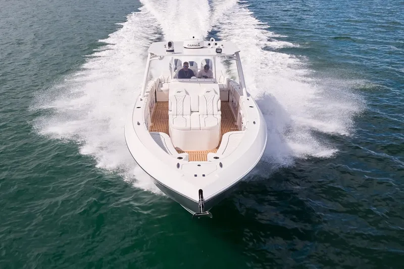 Slide: The Image of 2024 Midnight Express boat speeding on open water, showcasing sleek design and powerful performance. - 2