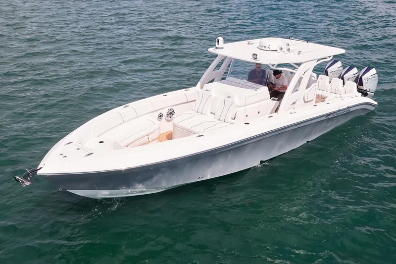 Slide: The Image of 2024 Midnight Express boat cruising on open water, featuring sleek design and powerful engines. - 6