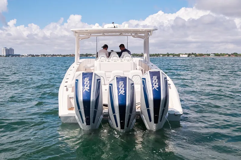 Slide: The Image of 2024 Midnight Express boat with triple 500R engines cruising on open water. - 7