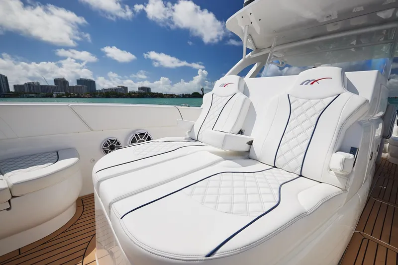 Slide: The Image of Luxurious seating on a 2024 Midnight Express boat, featuring white quilted upholstery. - 9