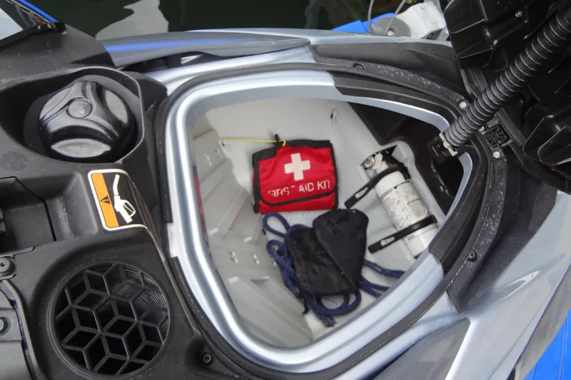 Slide: The Image of Open storage compartment of 2021 Seadoo GTI 170 SE with first aid kit and fire extinguisher. - 12