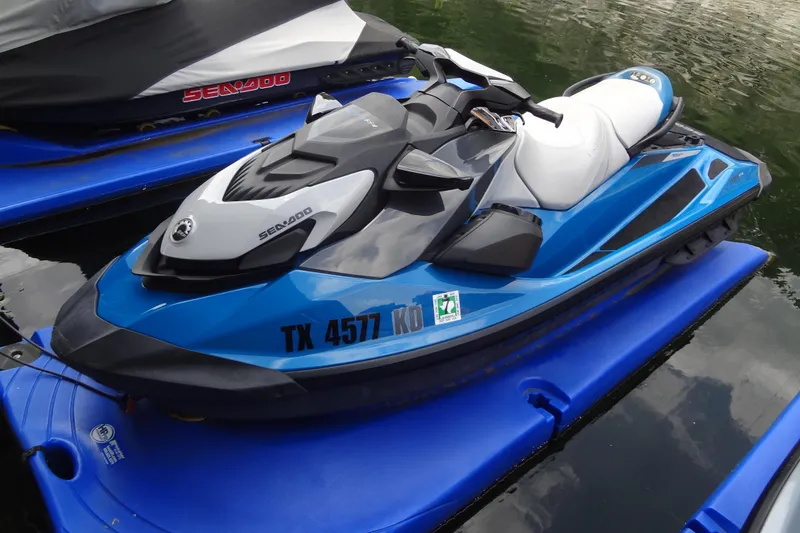 Slide: The Image of 2021 Seadoo GTI 170 SE jet ski in blue, docked on water. - 14