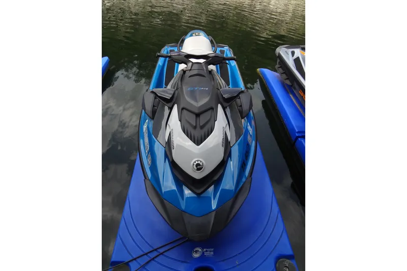 Slide: The Image of 2021 Seadoo GTI 170 SE jet ski in blue, docked on water. - 15