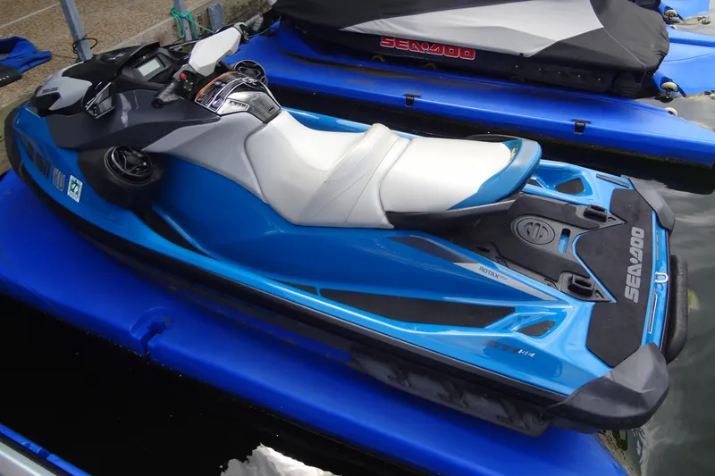 Slide: The Image of 2021 Seadoo GTI 170 SE jet ski in blue, docked on water. - 16