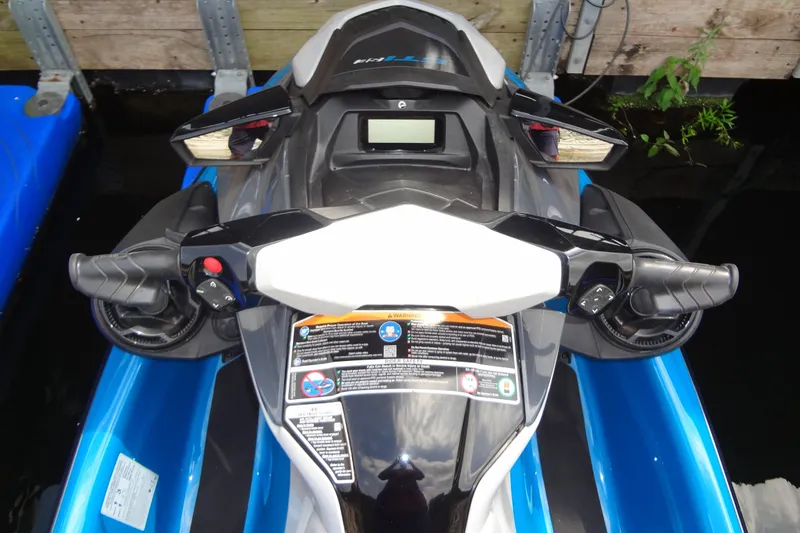 Slide: The Image of 2021 Seadoo GTI 170 SE jet ski handlebars and dashboard, docked on water. - 18
