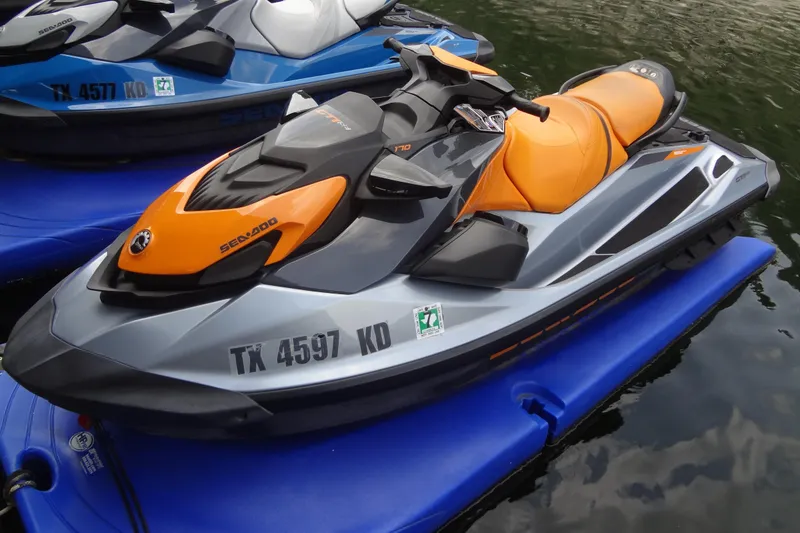 Slide: The Image of 2021 Seadoo GTI 170 SE jet ski with orange and gray design on water. - 5