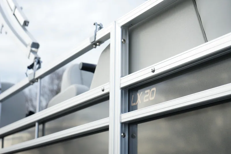Slide: The Image of Close-up of a 2025 Starcraft LX 16 R pontoon boat railing. - 12