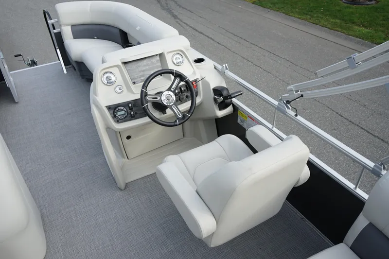 Slide: The Image of 2025 Starcraft LX 16 R boat interior with steering console and seating. - 6