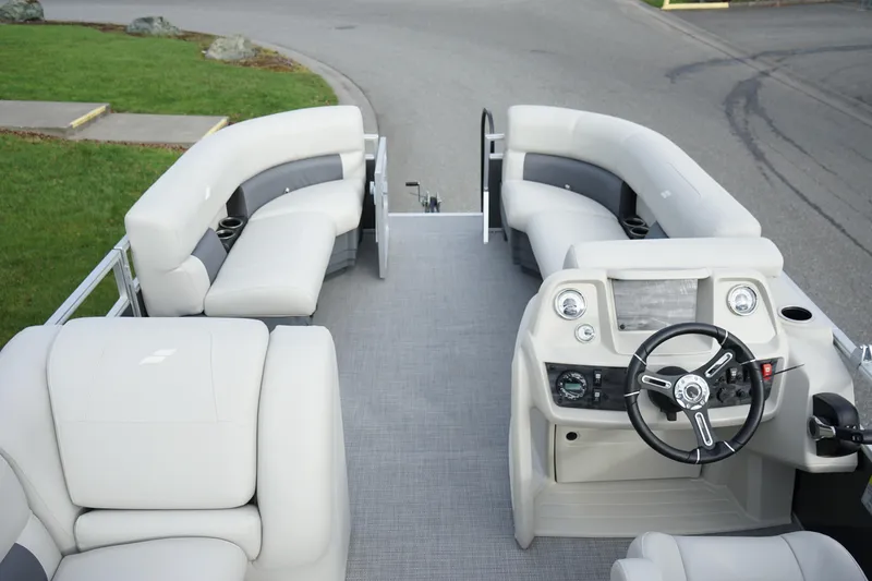 Slide: The Image of 2025 Starcraft LX 16 R pontoon boat interior with plush seating and modern helm. - 7