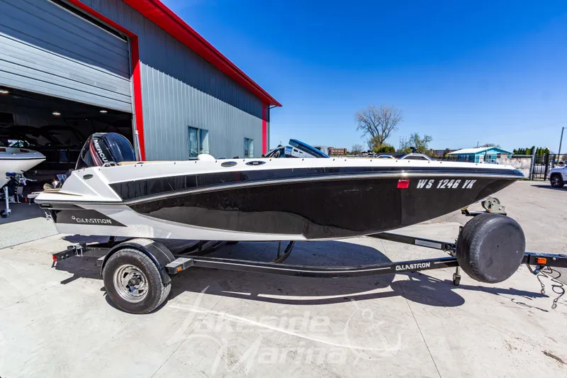 The Image of 2019 Glastron GTD 180 boat on trailer outside a marina. - 1