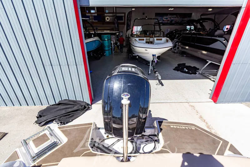 Slide: The Image of 2019 Glastron GTD 180 boat in a showroom with other boats. - 11