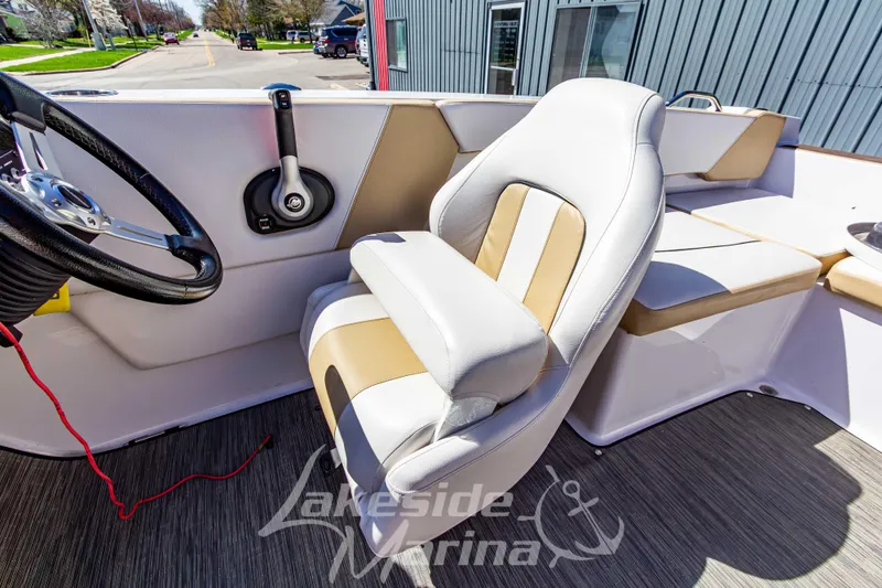 Slide: The Image of 2019 Glastron GTD 180 boat interior with steering wheel and cushioned seating. - 20