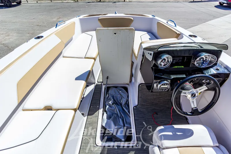 Slide: The Image of 2019 Glastron GTD 180 boat interior with steering wheel and seating area. - 24