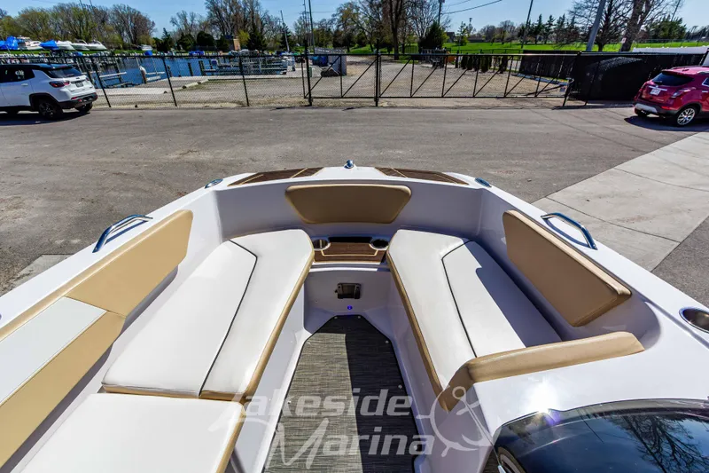 Slide: The Image of 2019 Glastron GTD 180 boat interior with beige seating, docked at marina. - 26