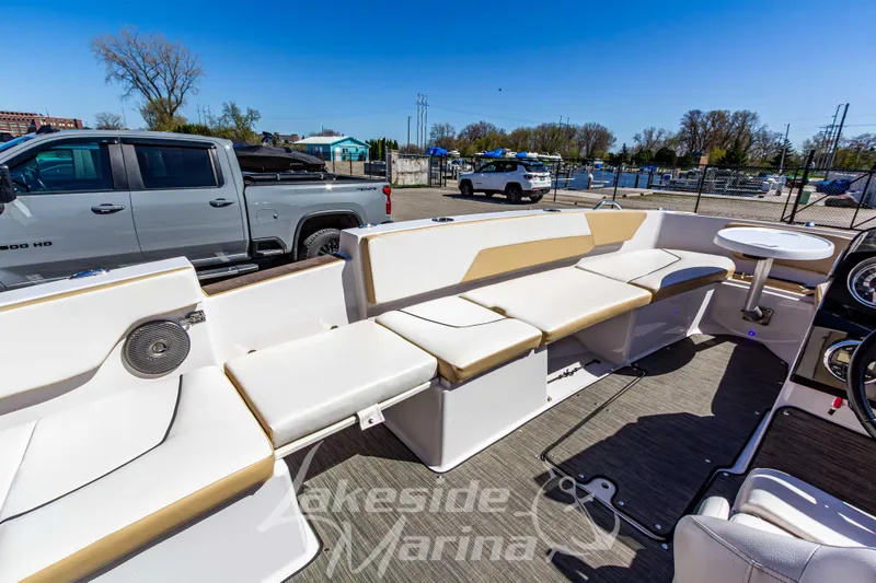 Slide: The Image of 2019 Glastron GTD 180 boat interior with beige seating and a small table. - 28
