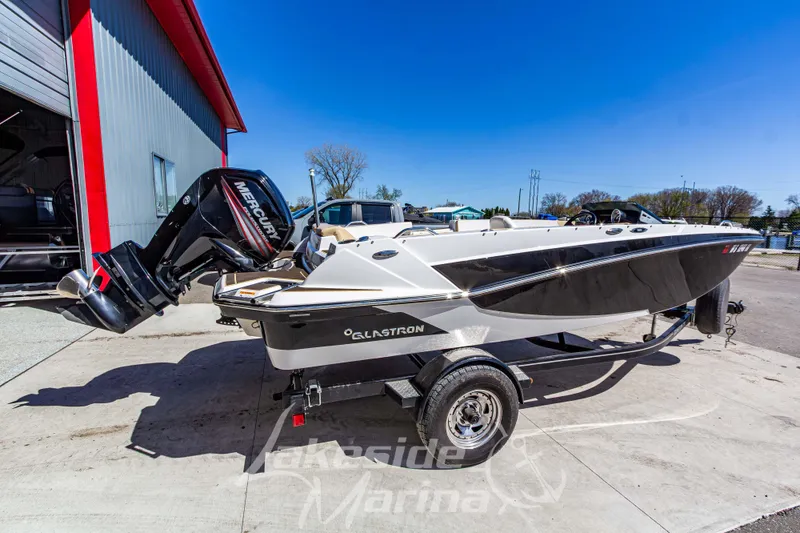 Slide: The Image of 2019 Glastron GTD 180 boat with Mercury engine on trailer, parked outside marina. - 3