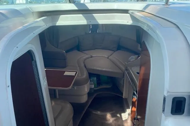 Slide: The Image of Interior of a 2001 Monterey 302 Cruiser boat with seating and table. - 12