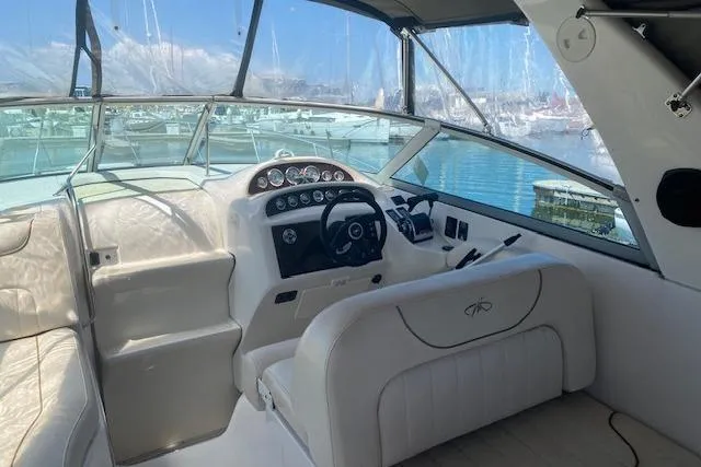 Slide: The Image of Cockpit of 2001 Monterey 302 Cruiser with steering wheel and dashboard, docked at marina. - 4