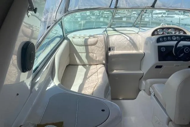 Slide: The Image of Interior of a 2001 Monterey 302 Cruiser boat with beige seating and dashboard. - 5