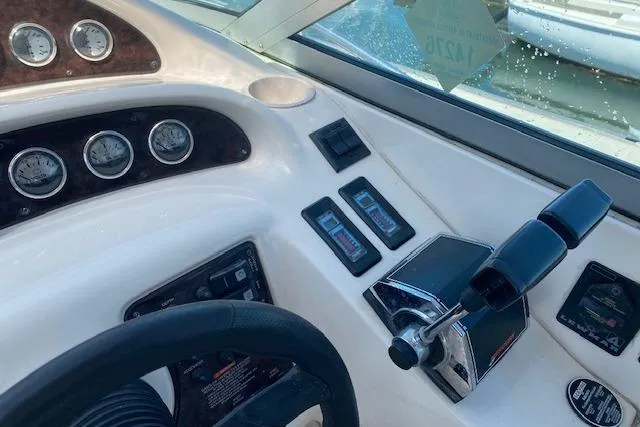 Slide: The Image of Cockpit controls of a 2001 Monterey 302 Cruiser boat, featuring gauges and throttle. - 9