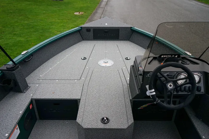 Slide: The Image of 2026 Lund 1800 Explorer Sport boat interior with steering console and spacious deck. - 11