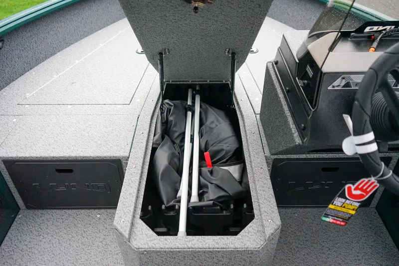 Slide: The Image of 2026 Lund 1800 Explorer Sport boat interior storage compartment open. - 12