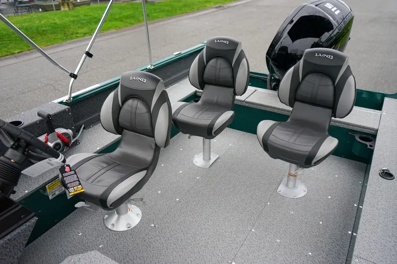 Slide: The Image of 2026 Lund 1800 Explorer Sport boat interior with three gray seats and motor. - 8
