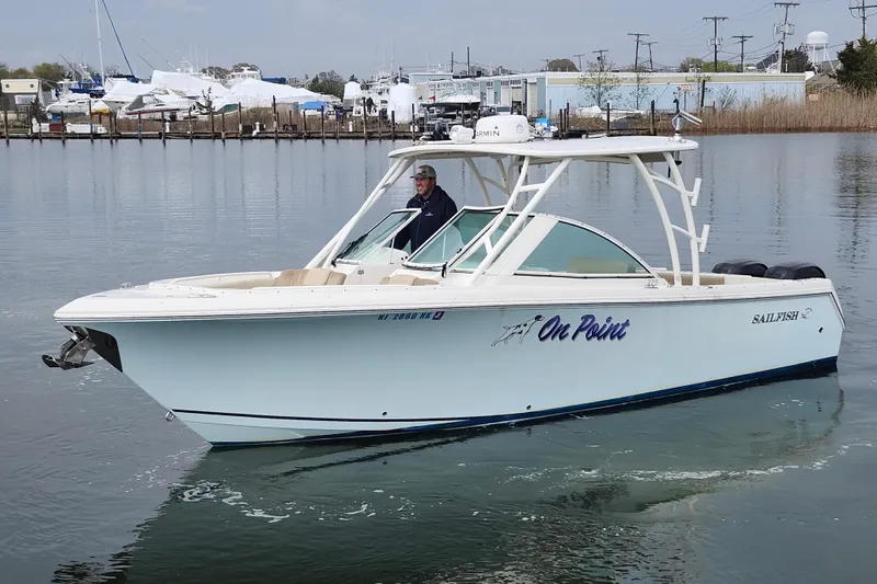 Slide: The Image of 2017 Sailfish 275 DC helm with navigation system, steering wheel, and control panel. - 16