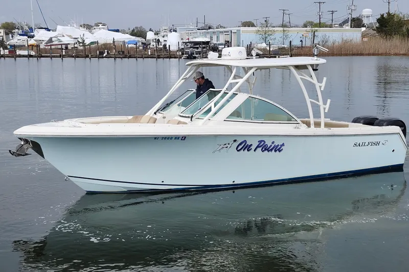 Slide: The Image of 2017 Sailfish 275 DC boat interior with beige seating and cup holders. - 17