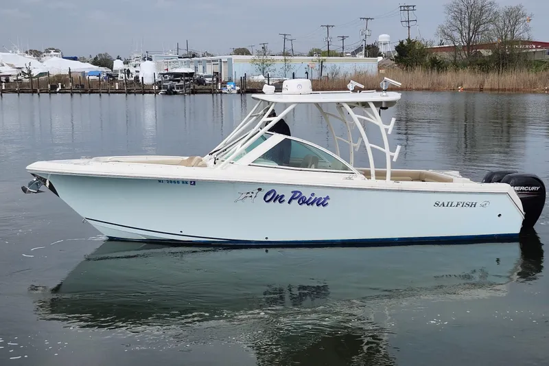 Slide: The Image of 2017 Sailfish 275 DC boat interior with beige seating and wet surfaces. - 18