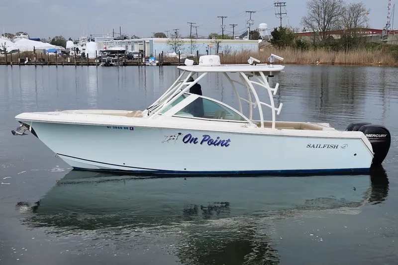 Slide: The Image of 2017 Sailfish 275 DC boat interior with helm, sink, and storage compartments. - 19