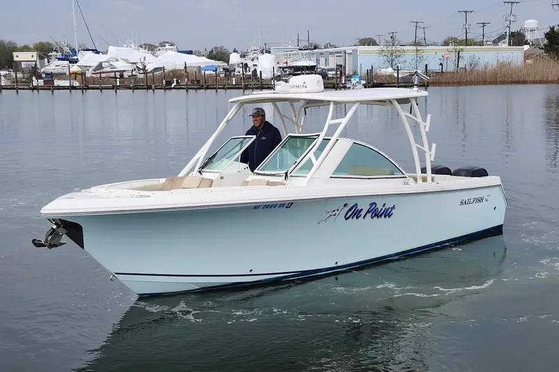 Slide: The Image of 2017 Sailfish 275 DC boat on calm water, featuring sleek design and modern amenities. - 2