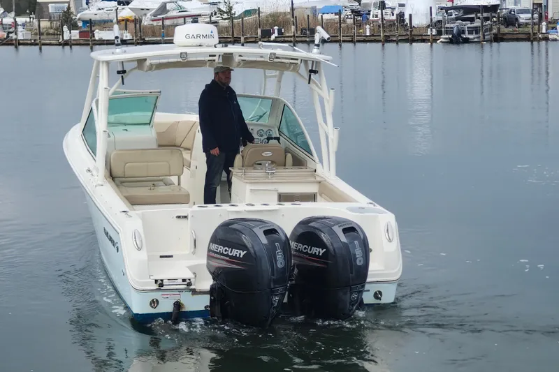 Slide: The Image of 2017 Sailfish 275 DC boat interior with sink, countertop, and cup holders. - 20