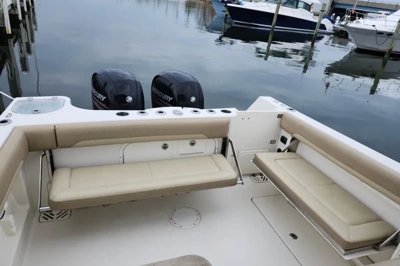 Slide: The Image of 2017 Sailfish 275 DC boat interior with seating and twin Mercury engines. - 22